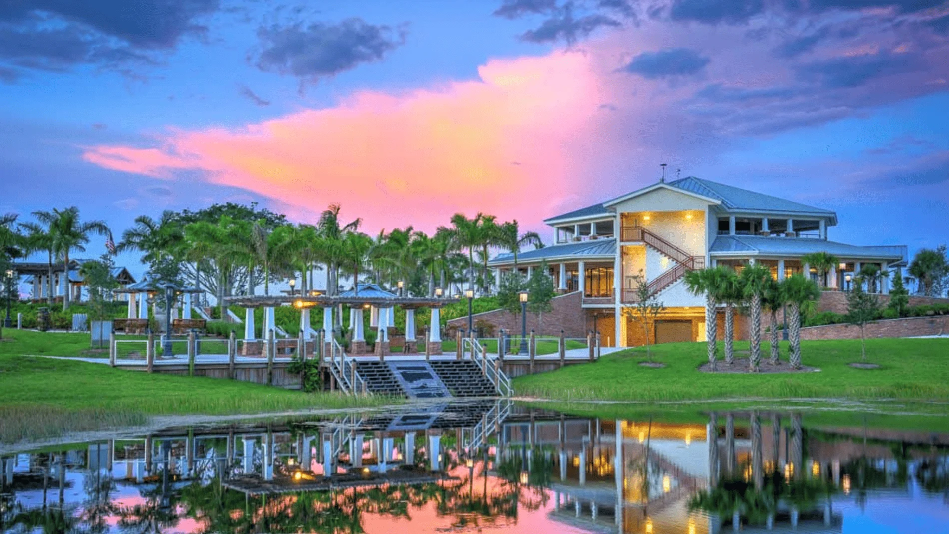 Clubhouse with palm trees and sunset reflection in Royal Palm Beach, Florida.
